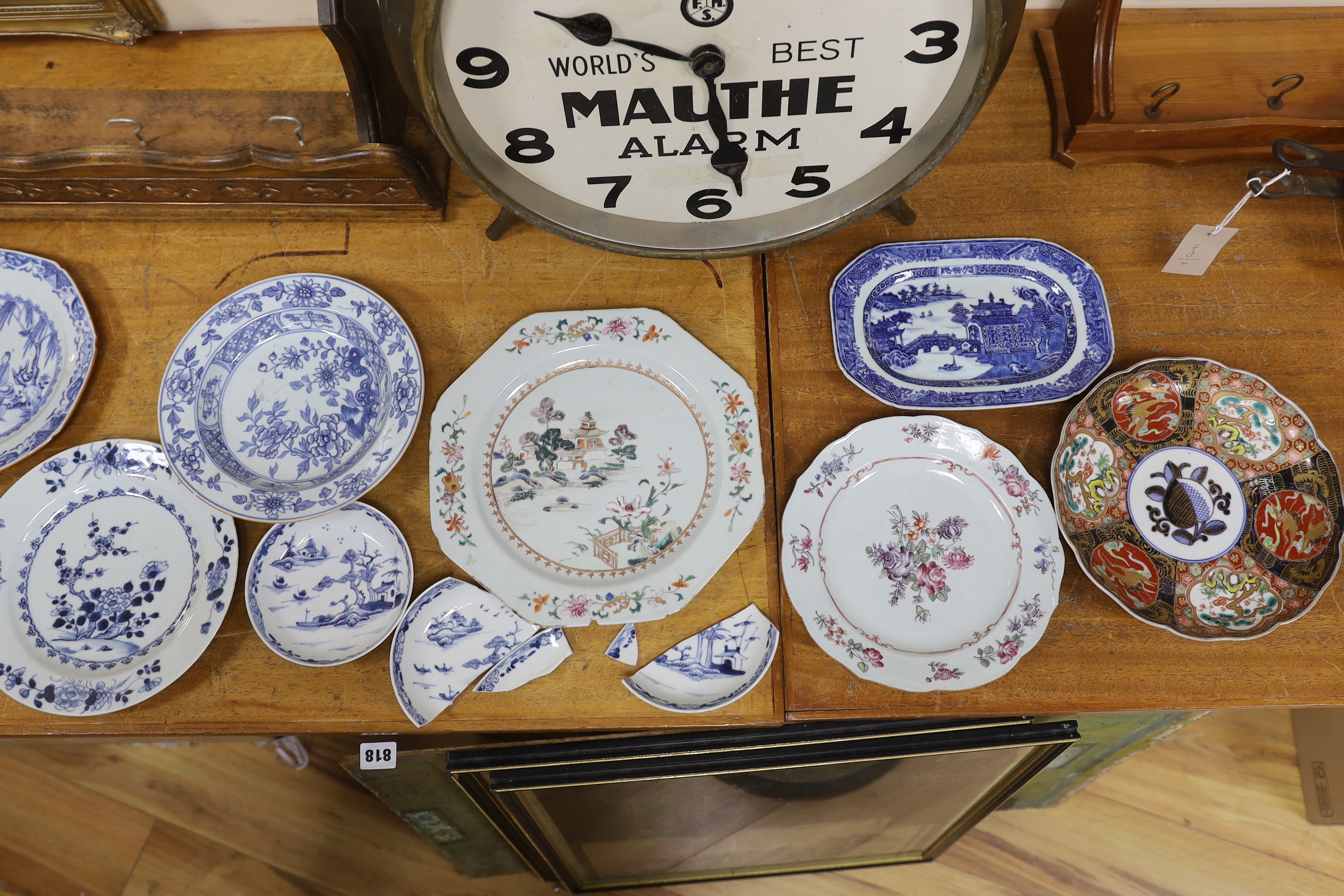 A group of 18th century Chinese porcelain plates and saucers, mostly blue and white and an octagonal famille rose example, together with three Japanese dishes, largest 27cm in diameter